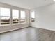 Open-concept living room with wood-look floors, white walls, large windows, and recessed lighting at 20378 Hudson Bay Ln, Westfield, IN 46074