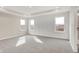 Spacious main bedroom with large windows offering scenic views and a tray ceiling for added elegance at 20378 Hudson Bay Ln, Westfield, IN 46074