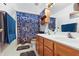Functional bathroom with a double sink, a toilet and a shower with a patterned shower curtain at 719 Trent Dr, Greenwood, IN 46143