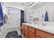 Bright bathroom featuring a double sink vanity, bathtub, and ample natural light at 719 Trent Dr, Greenwood, IN 46143