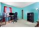 Bedroom with teal walls, carpet flooring, and a black desk and chair at 719 Trent Dr, Greenwood, IN 46143