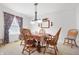 Formal dining room featuring six chairs, carpet flooring, and a decorative light fixture at 719 Trent Dr, Greenwood, IN 46143