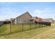An expansive backyard showcases a fenced perimeter and a meticulously cared for lawn, perfect for outdoor enjoyment at 8118 Ambrosia Ln, Pendleton, IN 46064