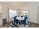 Bright dining area features a white table, seating for four, modern chandelier, and sliding glass doors at 8118 Ambrosia Ln, Pendleton, IN 46064