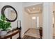 Inviting entryway featuring neutral walls, modern decor, a round mirror, and an accent table at 8118 Ambrosia Ln, Pendleton, IN 46064