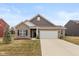 Charming single-story home features a brick facade, attached garage, and manicured front lawn at 8118 Ambrosia Ln, Pendleton, IN 46064