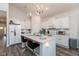 Modern kitchen features white cabinets, granite counters, an island with seating, and stainless appliances at 8118 Ambrosia Ln, Pendleton, IN 46064