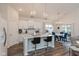 Open kitchen and dining area with island seating, granite counters, white cabinets, and stainless appliances at 8118 Ambrosia Ln, Pendleton, IN 46064