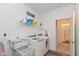 Bright laundry room features modern appliances, storage shelf, and an open doorway at 8118 Ambrosia Ln, Pendleton, IN 46064