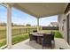 Covered patio has dining table and chairs with a view of the backyard at 8118 Ambrosia Ln, Pendleton, IN 46064