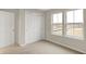Bedroom with sliding door closet, neutral walls and carpeted flooring with natural light from two windows at 413 Onset Way, Westfield, IN 46074