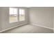 Bedroom with neutral walls and carpeted flooring with natural light from two windows at 413 Onset Way, Westfield, IN 46074