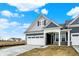 Beautiful home boasting a white garage door, blue siding, and a covered front porch at 413 Onset Way, Westfield, IN 46074