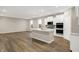 Open kitchen and living space featuring an island, stainless appliances, and modern finishes throughout at 413 Onset Way, Westfield, IN 46074