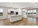 Bright kitchen showcasing an island, stainless steel appliances, white cabinets, and natural light at 413 Onset Way, Westfield, IN 46074