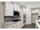 View of the kitchen featuring white cabinets, stainless steel appliances, a gas stovetop, and tile backsplash at 413 Onset Way, Westfield, IN 46074