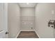 A simple laundry room with wood-look floors, painted light-grey walls and a wire shelf at 413 Onset Way, Westfield, IN 46074