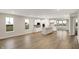 Open-concept living area with wood floors, white cabinets, and ample natural light at 413 Onset Way, Westfield, IN 46074