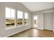 Bright room featuring hardwood floors, multiple windows, and access to the backyard at 413 Onset Way, Westfield, IN 46074