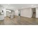 Expansive open-concept living area with wood floors, white cabinets, island, and staircase at 413 Onset Way, Westfield, IN 46074