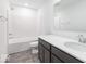 Bathroom with tub, toilet, and dark vanity at 1116 Bevy Blvd, Danville, IN 46122