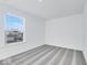 Well-lit bedroom, grey carpet, and a window view at 1116 Bevy Blvd, Danville, IN 46122