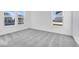 Bright bedroom with grey carpet and large windows at 1116 Bevy Blvd, Danville, IN 46122