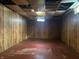 Unfinished basement space with wood paneling and a concrete floor at 3305 N Keystone Ave, Indianapolis, IN 46218