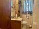 Cozy bathroom with vintage vanity, toilet, and shower, offering a functional and private space at 3305 N Keystone Ave, Indianapolis, IN 46218