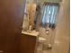 Bathroom with a sink, toilet, medicine cabinet, and shower with tiled walls at 3305 N Keystone Ave, Indianapolis, IN 46218