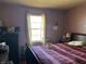 Bedroom featuring a large window, comfortable bedding, and ample storage at 3305 N Keystone Ave, Indianapolis, IN 46218