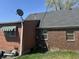 A detailed view of the home's exterior showcasing a brick and siding mix at 3305 N Keystone Ave, Indianapolis, IN 46218