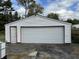 White detached garage with a large door and a smaller entrance at 3305 N Keystone Ave, Indianapolis, IN 46218