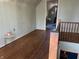 Hallway view showing hardwood floors and access to other rooms at 3305 N Keystone Ave, Indianapolis, IN 46218
