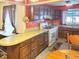 Traditional kitchen with wood cabinetry, light countertops, and a cozy breakfast nook near a large window at 3305 N Keystone Ave, Indianapolis, IN 46218