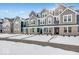 New townhome community with modern gray and brick exteriors, snow-covered landscaping, and attached garages at 5759 Cr W 750 N, McCordsville, IN 46055