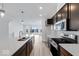 Modern kitchen with island, dark cabinets, and stainless steel appliances at 5759 Cr W 750 N, McCordsville, IN 46055