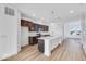 Modern kitchen with island, dark cabinets and stainless steel appliances at 5759 Cr W 750 N, McCordsville, IN 46055