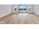 Bright living room with hardwood floors and sliding glass doors leading to a balcony at 5759 Cr W 750 N, McCordsville, IN 46055