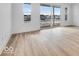 Living room with light wood-look flooring and sliding glass doors leading to a balcony at 5759 Cr W 750 N, McCordsville, IN 46055