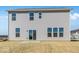 Two-story home featuring large windows, sliding door, and a backyard with grass at 475 Chester Ln, Pittsboro, IN 46167