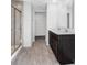 Bathroom with a double sink vanity, glass enclosed shower, and wood look vinyl flooring at 475 Chester Ln, Pittsboro, IN 46167