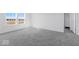 Spacious bedroom with plush carpeting, natural light from bright windows, and a closet at 475 Chester Ln, Pittsboro, IN 46167