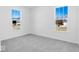Bright bedroom with plush carpeting, two windows, and ample natural light at 475 Chester Ln, Pittsboro, IN 46167