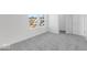 Bedroom with neutral carpeting and a large window showcasing the neighborhood at 475 Chester Ln, Pittsboro, IN 46167