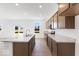 Bright kitchen with stainless steel appliances, granite countertops, and a center island at 475 Chester Ln, Pittsboro, IN 46167