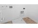 Bright laundry room with tile-look vinyl flooring and modern utility connections at 475 Chester Ln, Pittsboro, IN 46167