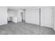 Upstairs loft space with plush carpeting, a view of a staircase, and multiple doorways at 475 Chester Ln, Pittsboro, IN 46167