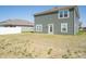 A view of the backyard with an exterior wall of the home with green siding at 1217 Fleming Dr, Greenfield, IN 46140