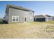Backyard view showcasing the home's exterior, green siding, and lawn at 1217 Fleming Dr, Greenfield, IN 46140